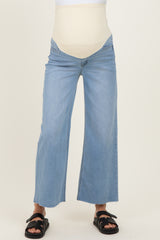 maternity wear light blue wide-leg jeans with a beige belly support panel worn by a model