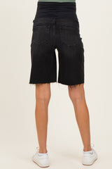 woman wearing black maternity shorts with a stretchy waistband and distressed hem