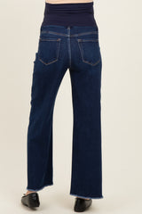 woman wearing dark blue wide leg maternity jeans, with a view of the back and frayed hem details