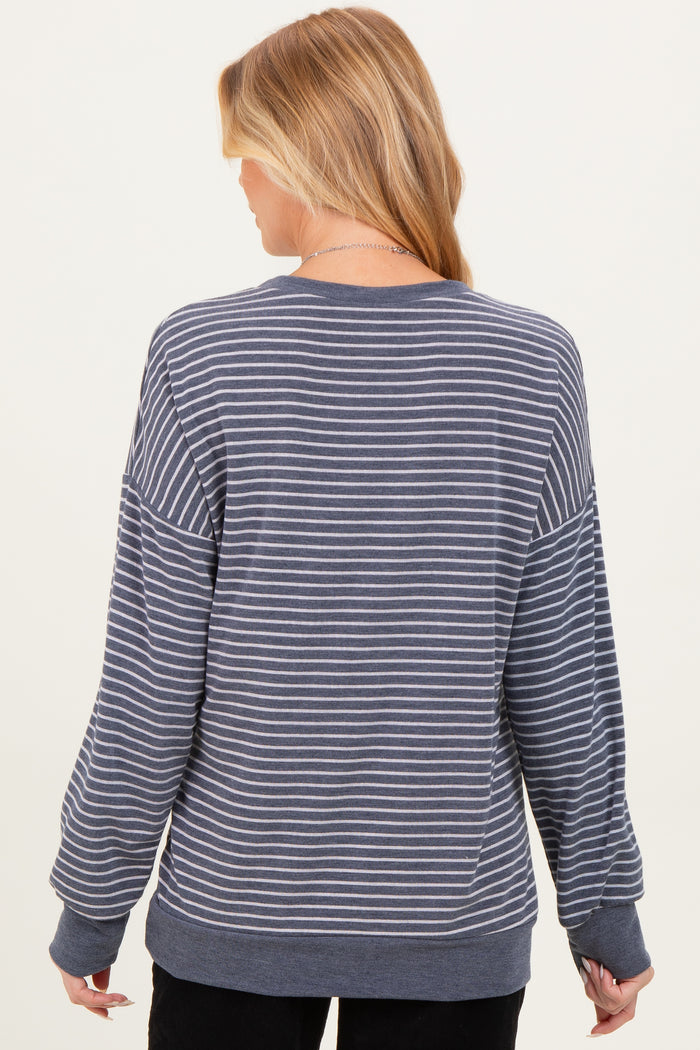 woman wearing a gray and white striped maternity sweatshirt with a relaxed fit and long sleeves