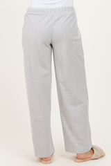 woman wearing light gray wide-leg lounge pants, view from the back, paired with cozy slippers