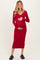 woman wearing a red ribbed maternity dress with long sleeves and a v-neck, holding her baby bump