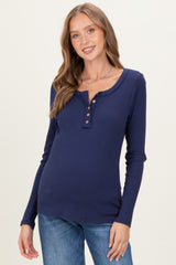 woman wearing a navy blue ribbed long sleeve maternity top with button details and a visible baby bump
