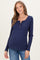 woman wearing a navy blue ribbed long sleeve maternity top with button details and a visible baby bump