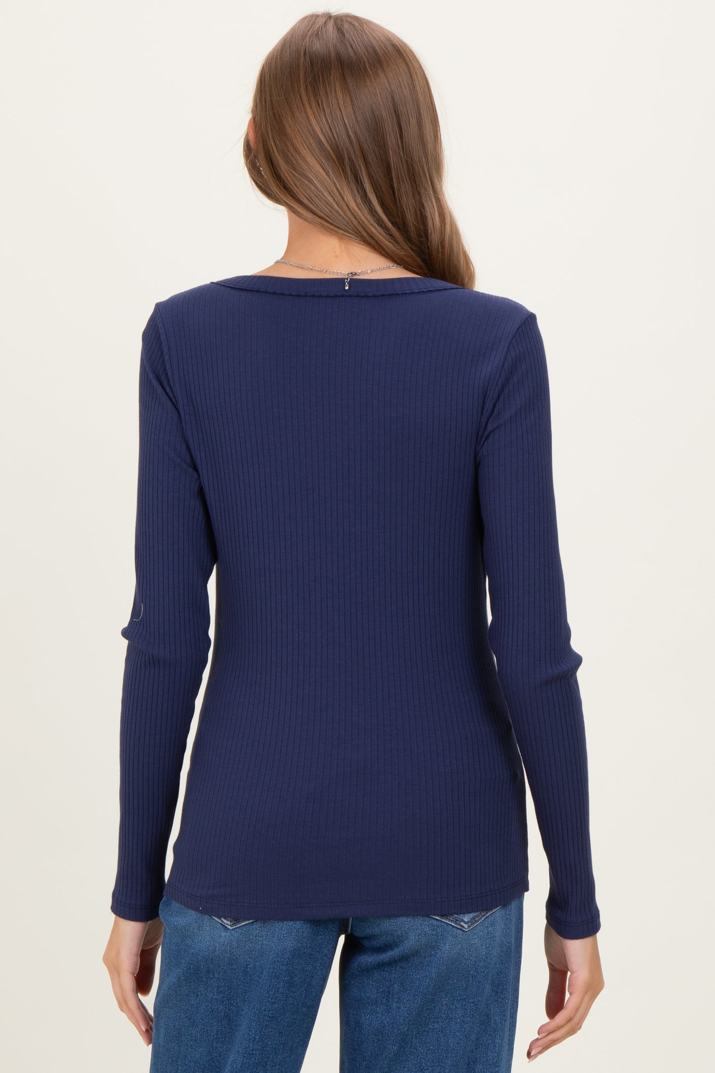 woman wearing a navy ribbed long sleeve maternity top viewed from the back