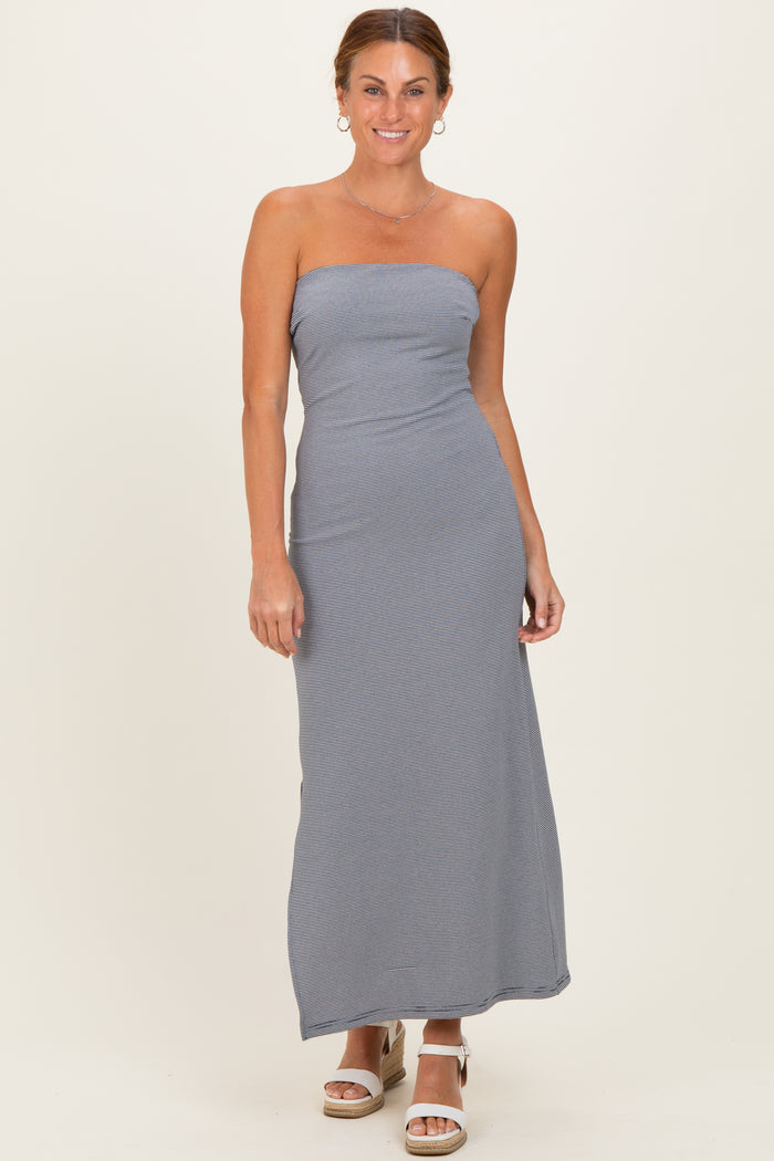 woman wearing a strapless gray striped maxi dress with a fitted bodice and relaxed skirt