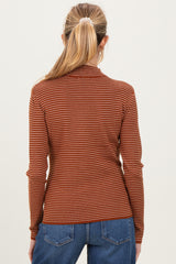 woman wearing a rust and cream striped maternity top with long sleeves, view from the back