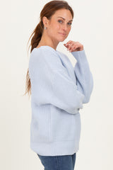 woman wearing a light blue oversized knit sweater with a relaxed fit and long sleeves