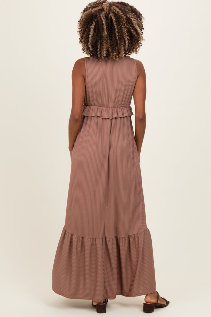 woman wearing a dusty rose maternity maxi dress with a ruffled waist and side pockets