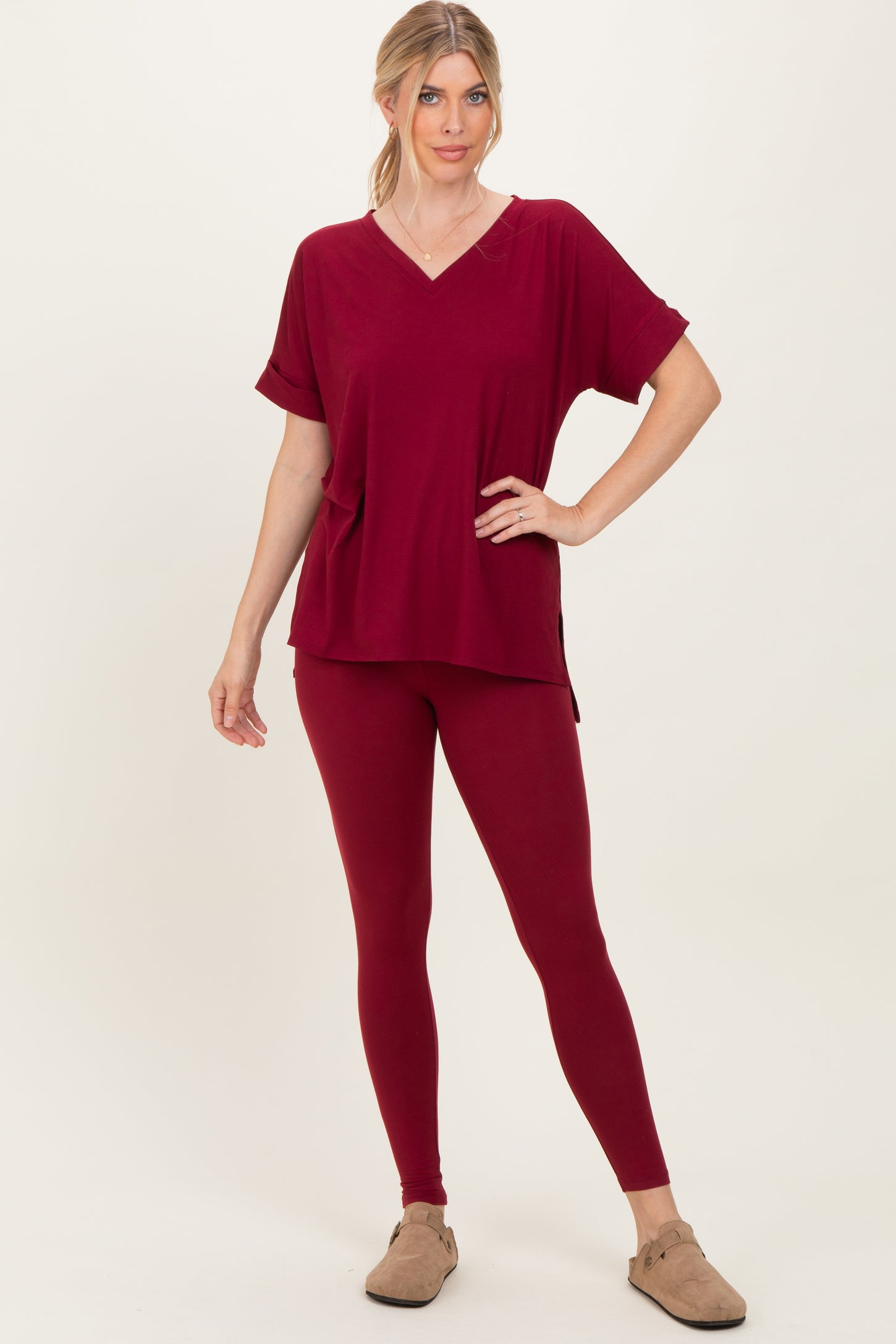 woman wearing a burgundy oversized v-neck top and matching leggings