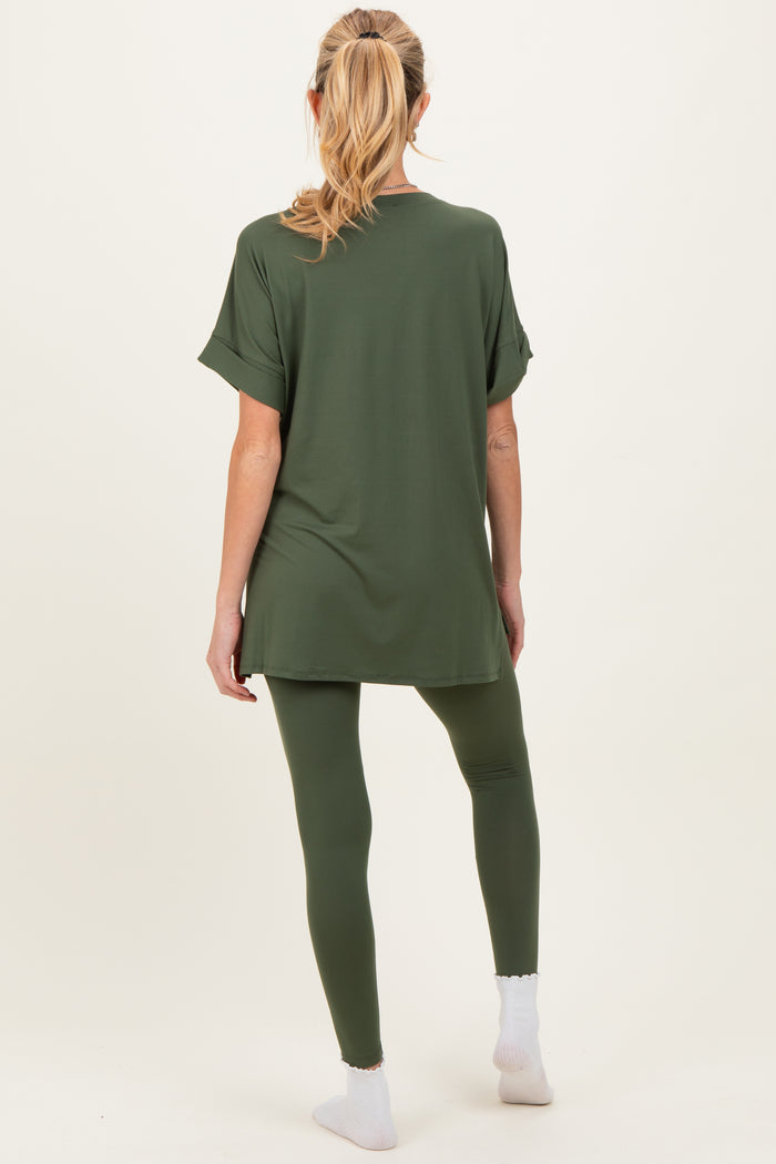 woman wearing an olive green maternity tunic top and matching leggings, with a relaxed fit and no visible baby bump