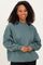 woman wearing a teal oversized sweatshirt with long sleeves and a crew neckline