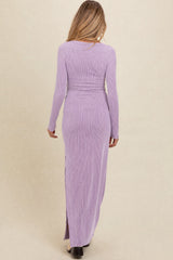 woman wearing a lavender long sleeve maternity maxi dress with a ribbed texture and side slit, showing a baby bump