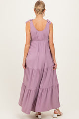 woman wearing a lavender maternity maxi dress with tie straps and tiered ruffles from the back