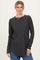 woman wearing a dark gray long sleeve top with a rounded hem and relaxed fit, paired with blue jeans