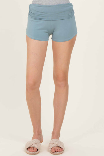 woman wearing a light blue high-waisted athletic short with a fold-over waistband and soft texture