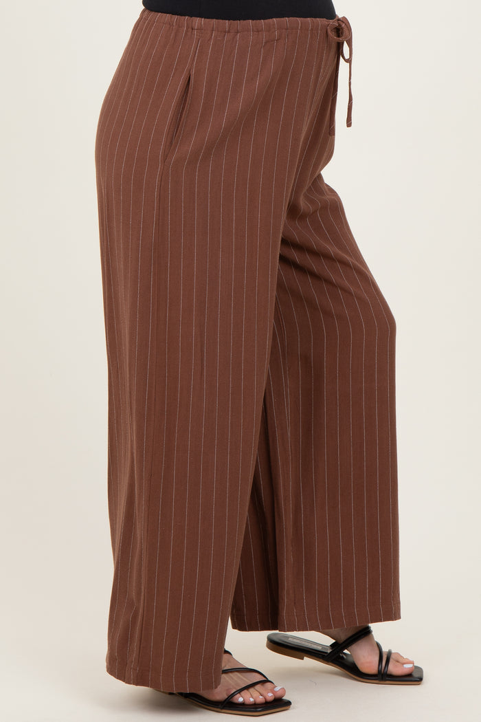 woman wearing brown striped maternity wide-leg pants with a drawstring waist and side slits