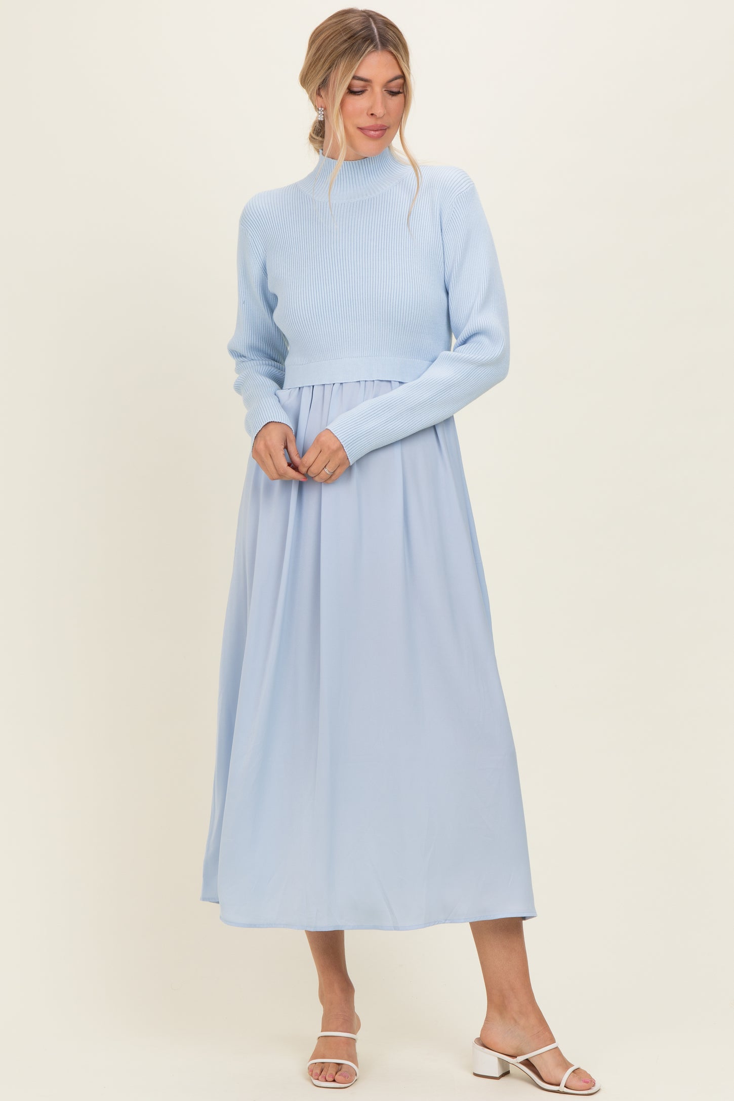 woman wearing a light blue cropped sweater and a flowing light blue maxi skirt