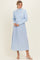 woman wearing a light blue cropped sweater and a flowing light blue maxi skirt