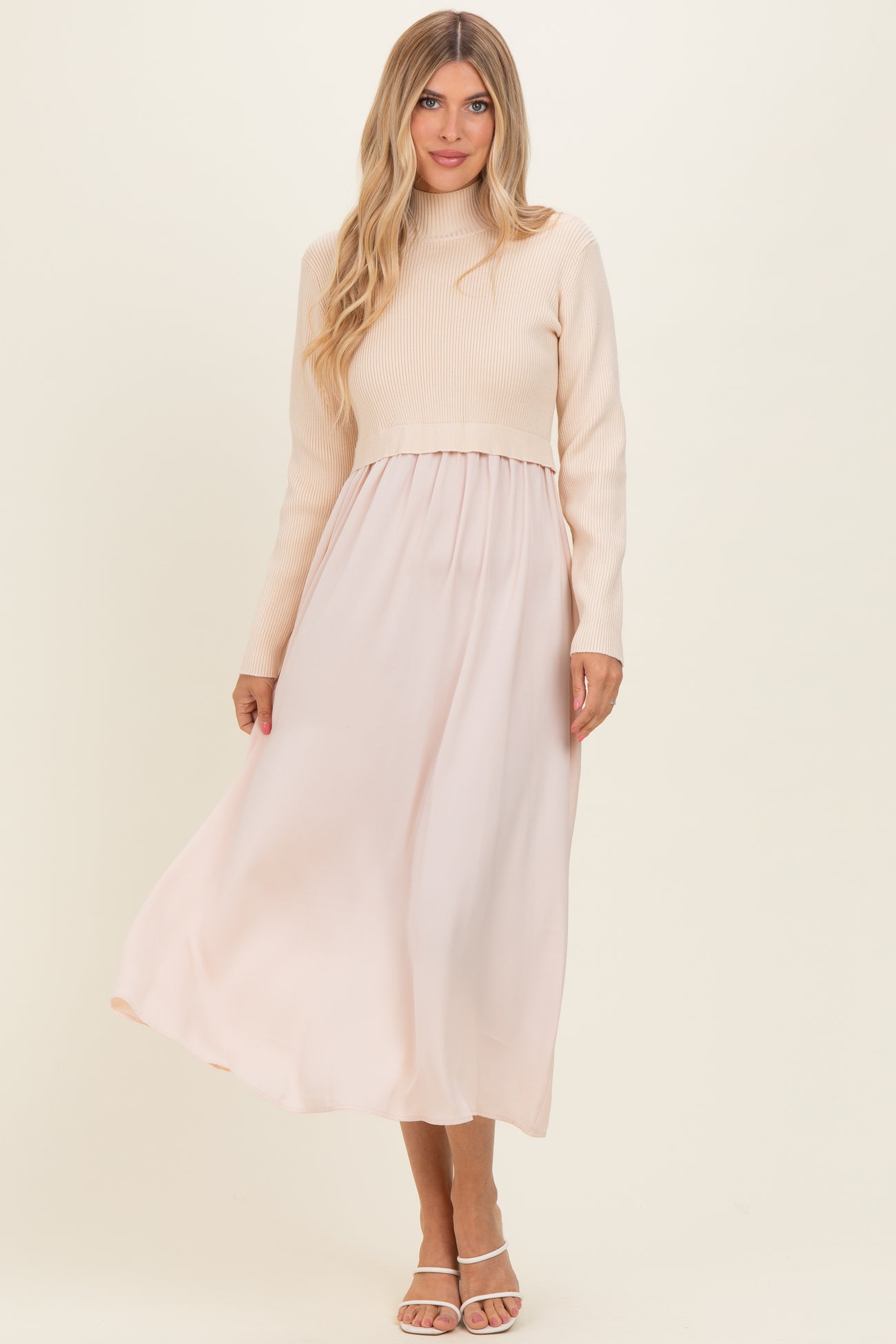 woman wearing a cream ribbed long sleeve top with a flowing blush maxi skirt