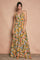 woman wearing a colorful maxi dress with a halter neck and tiered ruffled hem