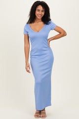 woman wearing a light blue short sleeve maxi dress with a v-neck and side slit