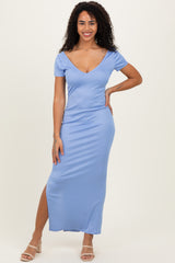 woman wearing a light blue ribbed maxi dress with a deep v-neck and a thigh-high slit