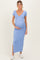 woman wearing a light blue maternity dress with a deep v-neck and side slit, showing her baby bump