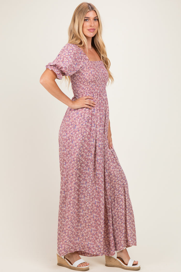 woman wearing a lilac floral maxi dress with puff sleeves and a fitted bodice, standing in profile