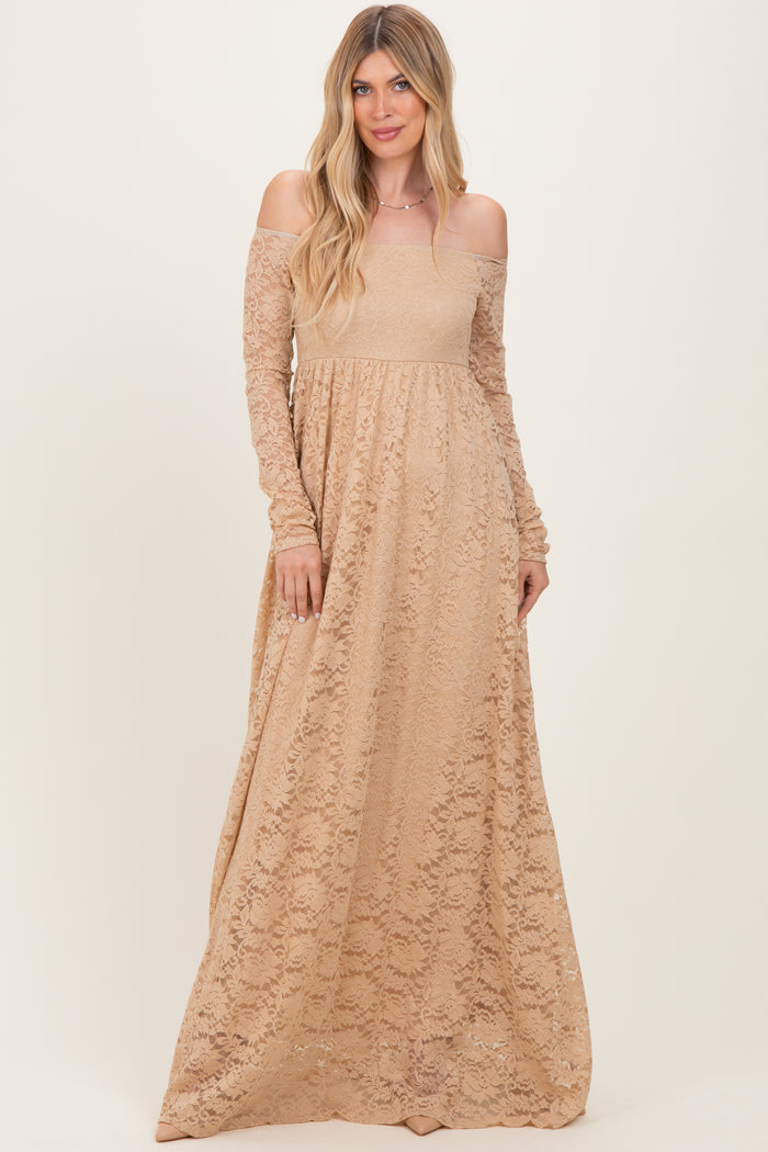 woman wearing a beige off-the-shoulder lace maxi dress with long sleeves and a flowy skirt