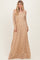 woman wearing a beige off-the-shoulder lace maxi dress with long sleeves and a flowy skirt