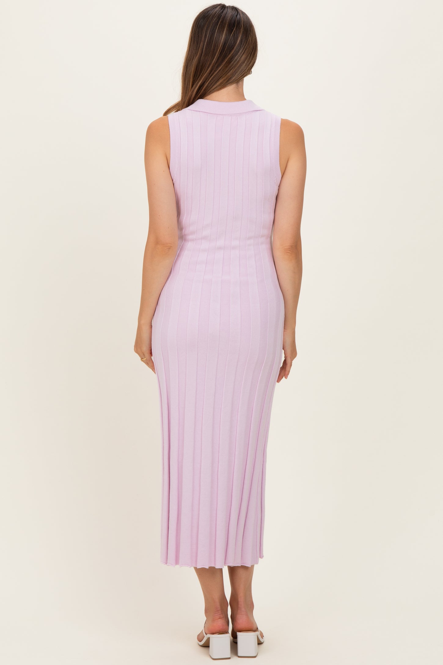 woman wearing a light pink ribbed sleeveless maternity maxi dress shown from the back