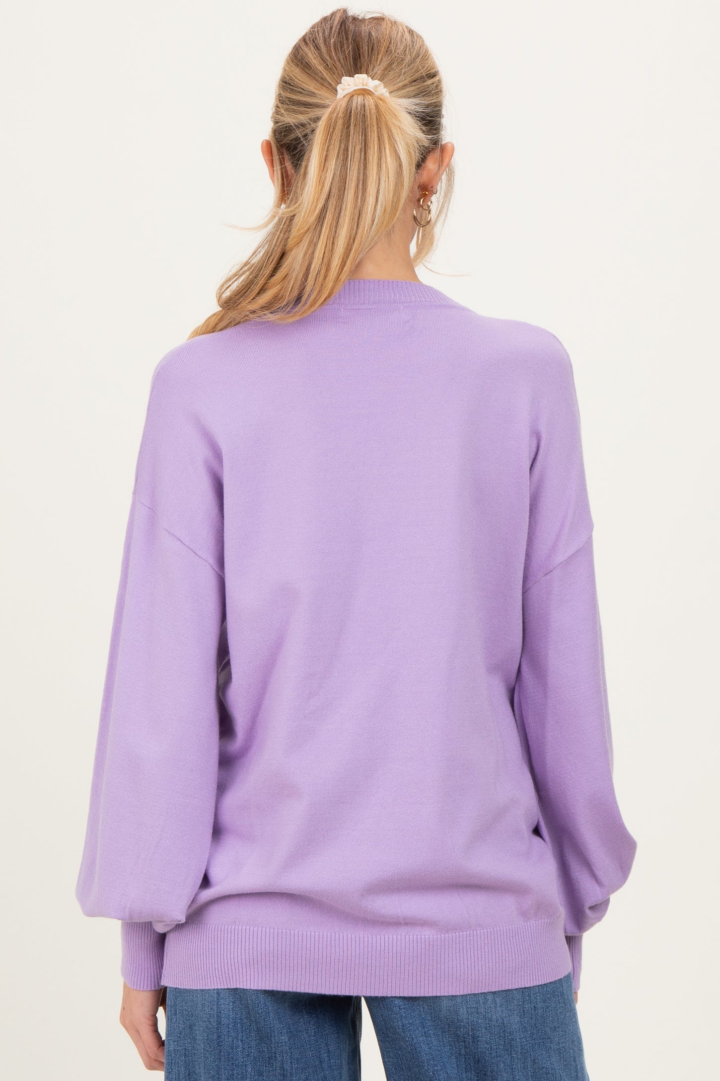 woman wearing a lavender oversized maternity sweater with balloon sleeves, viewed from the back