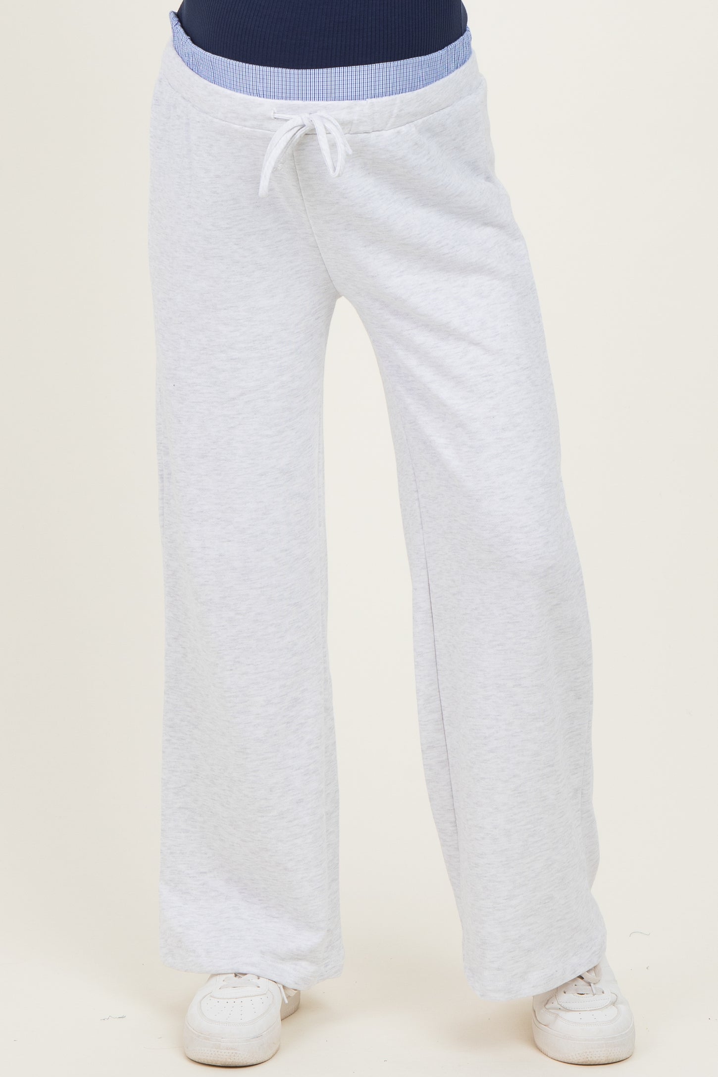 woman wearing light grey maternity sweatpants with a drawstring waist and wide-leg style