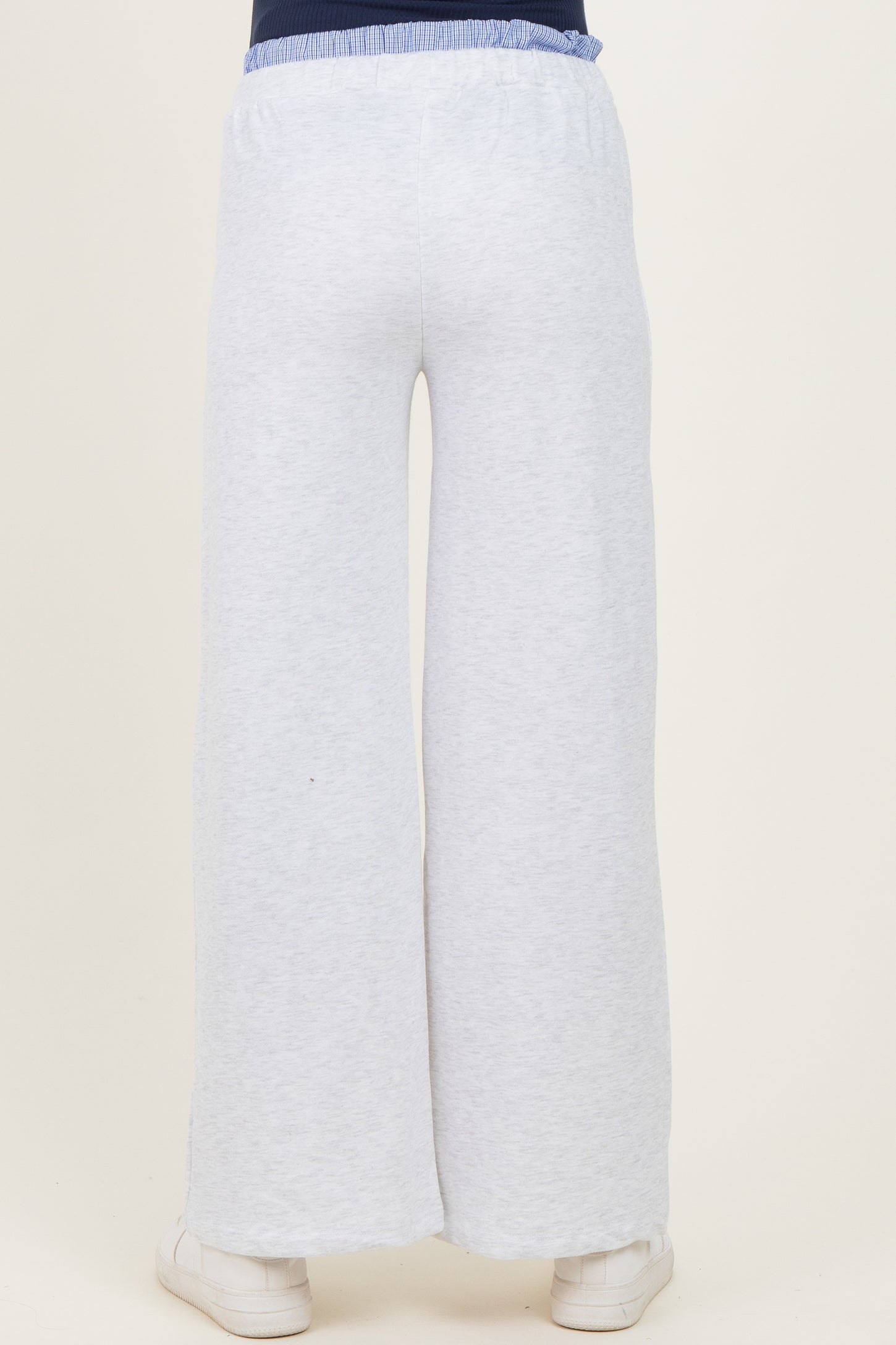 woman wearing light grey maternity wide-leg pants, view from the back showing a comfortable elastic waistband