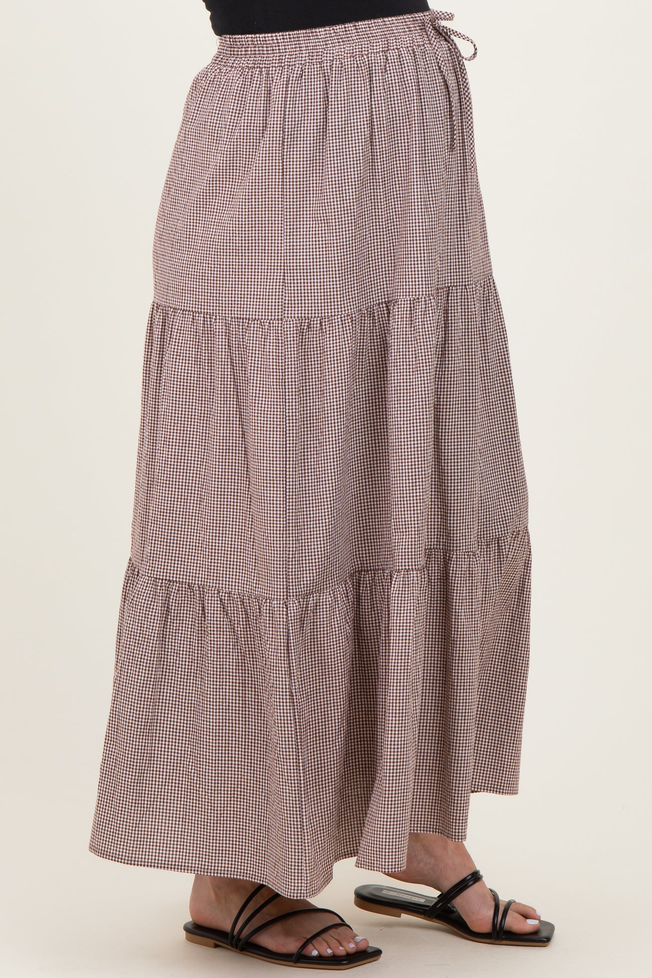maternity wear brown gingham tiered maxi skirt with elastic waistband, model wearing black sandals