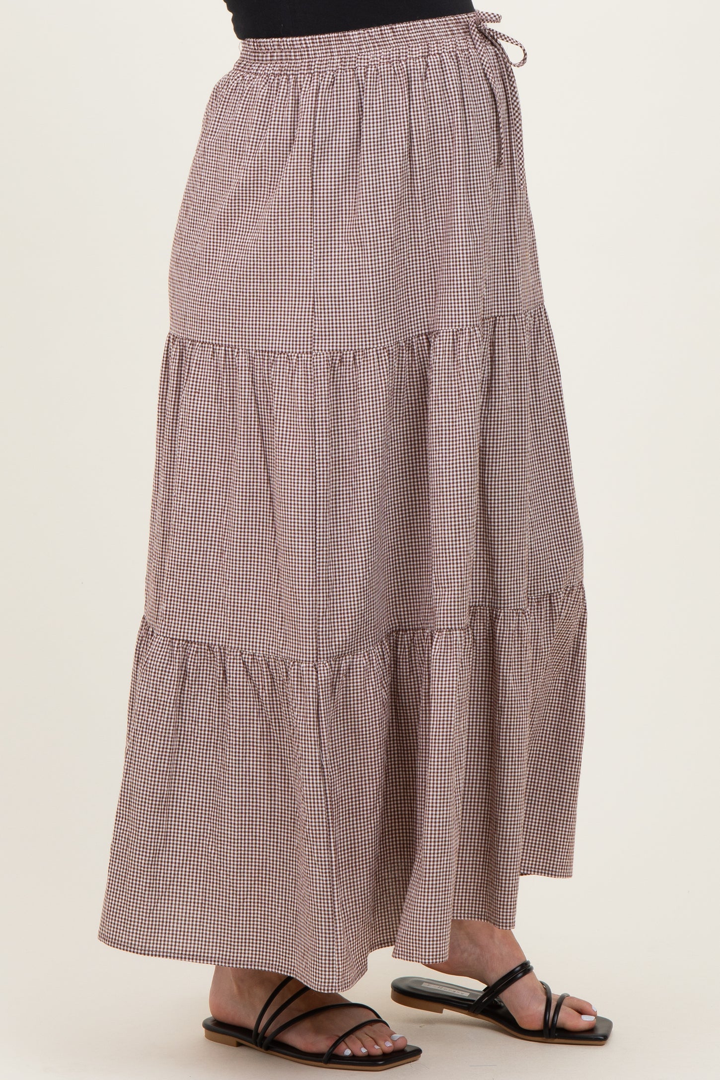 maternity wear brown gingham tiered maxi skirt with elastic waistband, model wearing black sandals