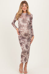 woman wearing a long sleeve pink and brown animal print maternity dress, showcasing her baby bump