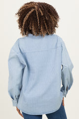 woman wearing a light blue maternity wear button-up shirt with a relaxed fit and long sleeves, showing the back view