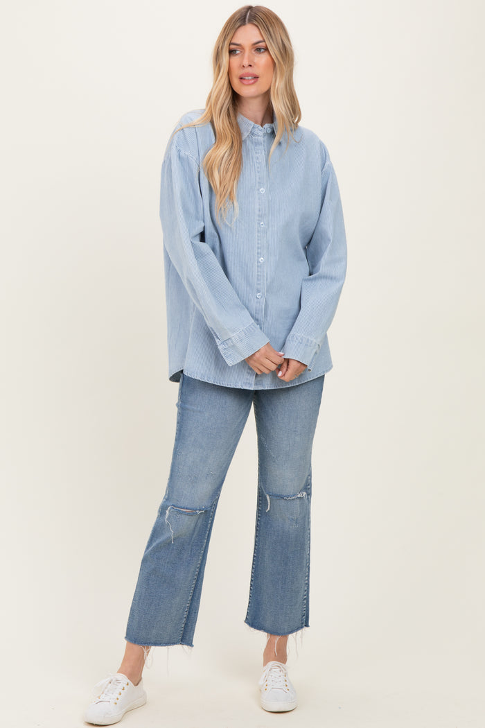 woman wearing a light blue striped button-up shirt and distressed flare jeans with white sneakers