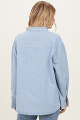 woman wearing a light blue striped oversized shirt, view from the back with long sleeves and relaxed fit