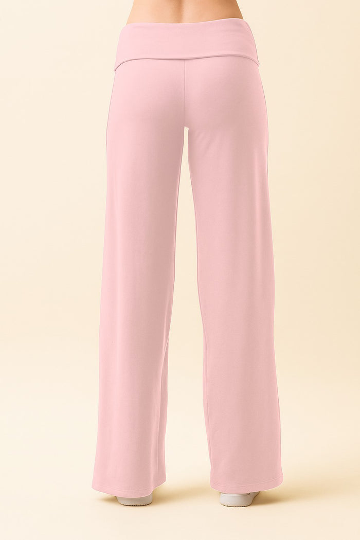 woman wearing pale pink wide-leg pants, viewed from the back