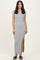 woman wearing a gray ribbed maxi dress with short sleeves and a side slit, standing on a neutral background