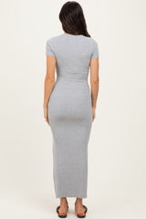 woman wearing a gray ribbed maxi dress with short sleeves and side slits, shown from the back