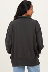 woman wearing a dark gray oversized maternity sweatshirt with a relaxed fit and dropped shoulders
