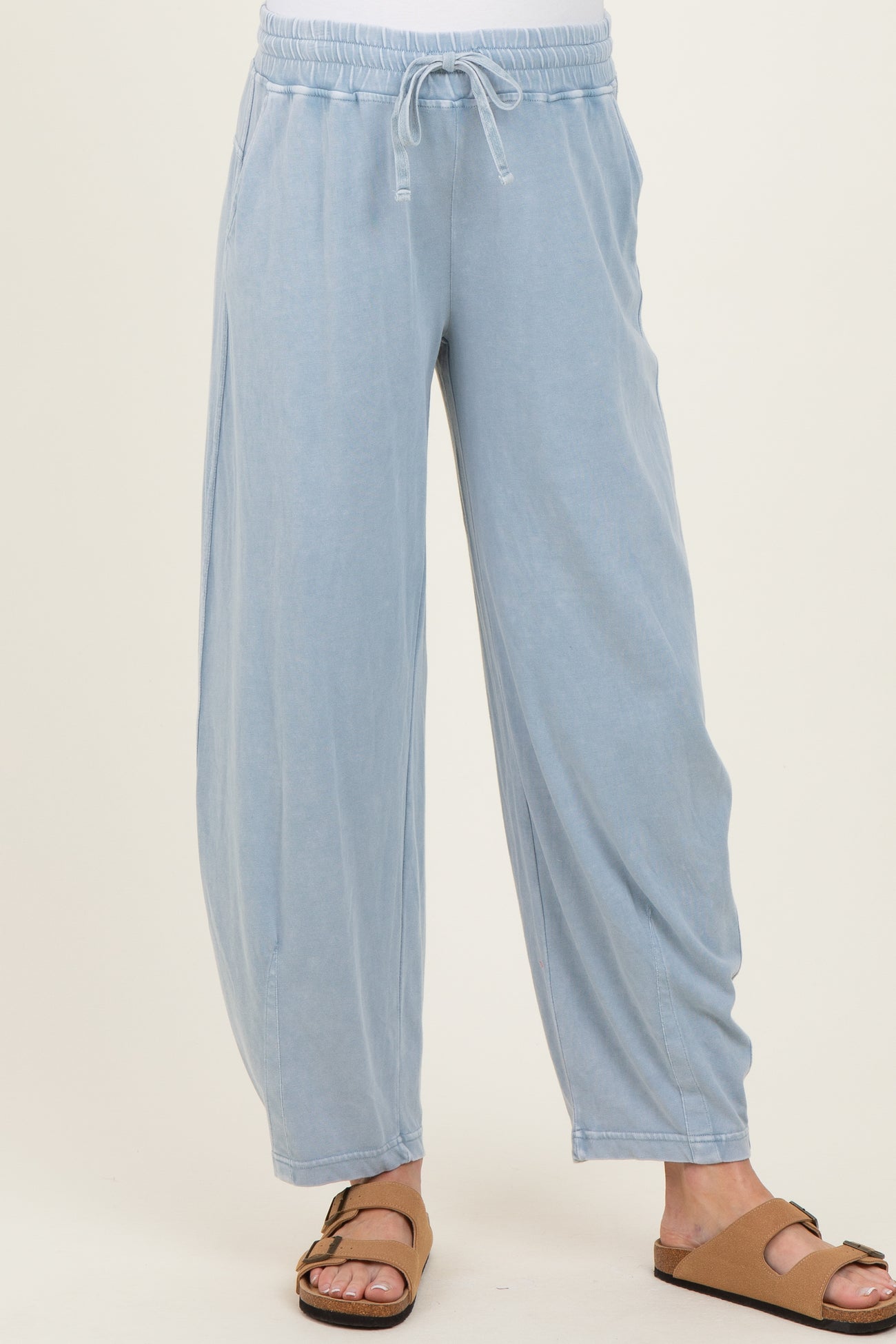 woman wearing light blue maternity lounge pants with an elastic waistband and side pockets
