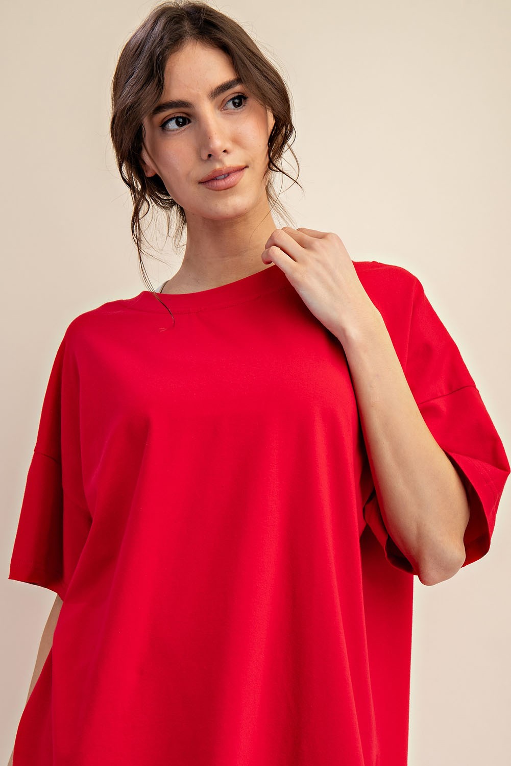 woman wearing a loose-fitting bright red oversized t-shirt with short sleeves