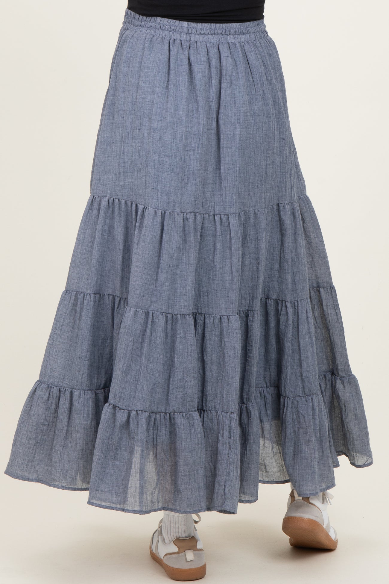 maternity wear tiered maxi skirt in a light blue chambray fabric with ruffle details and an elastic waistband