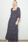woman wearing a black floral maxi dress with short puff sleeves and a square neckline
