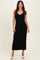 woman wearing a black ribbed knit midi dress with spaghetti straps and a fitted silhouette